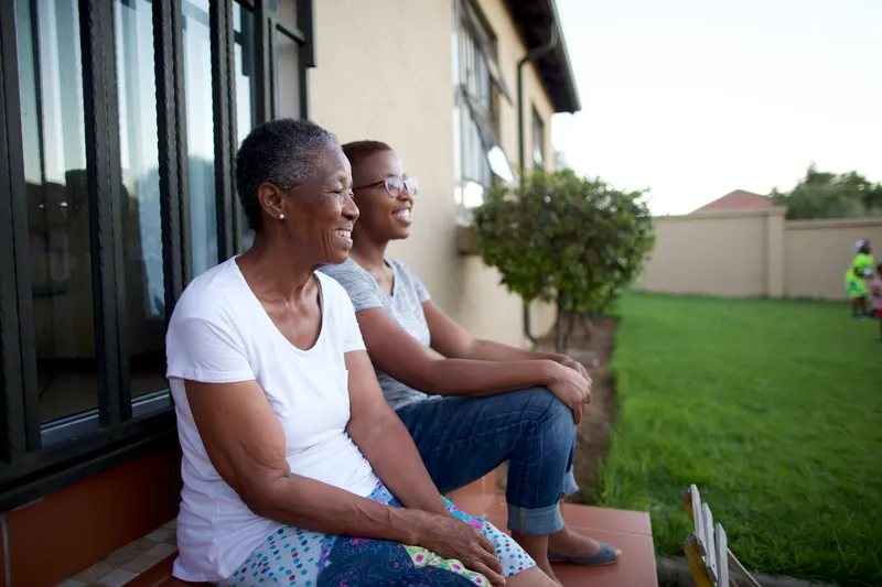 Women siting on a patio enjoying each other’s company