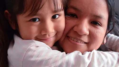 mother hugging daughter