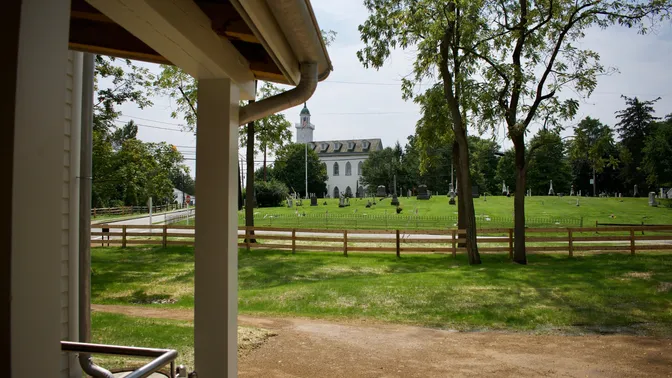 The Kirtland Temple can be seen in the distance from the restored home of Joseph and Emma Smith in Kirtland, Ohio. The home was dedicated on Saturday, August 26, 2023, by David A. Bednar of the Quorum of the Twelve Apostles of The Church of Jesus Christ of Latter-day Saints.