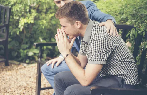 two men sitting on bench