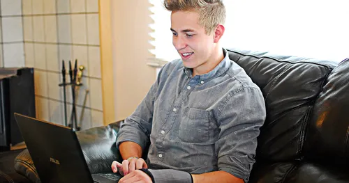 young man looking at computer