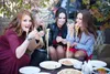 three women eating pasta