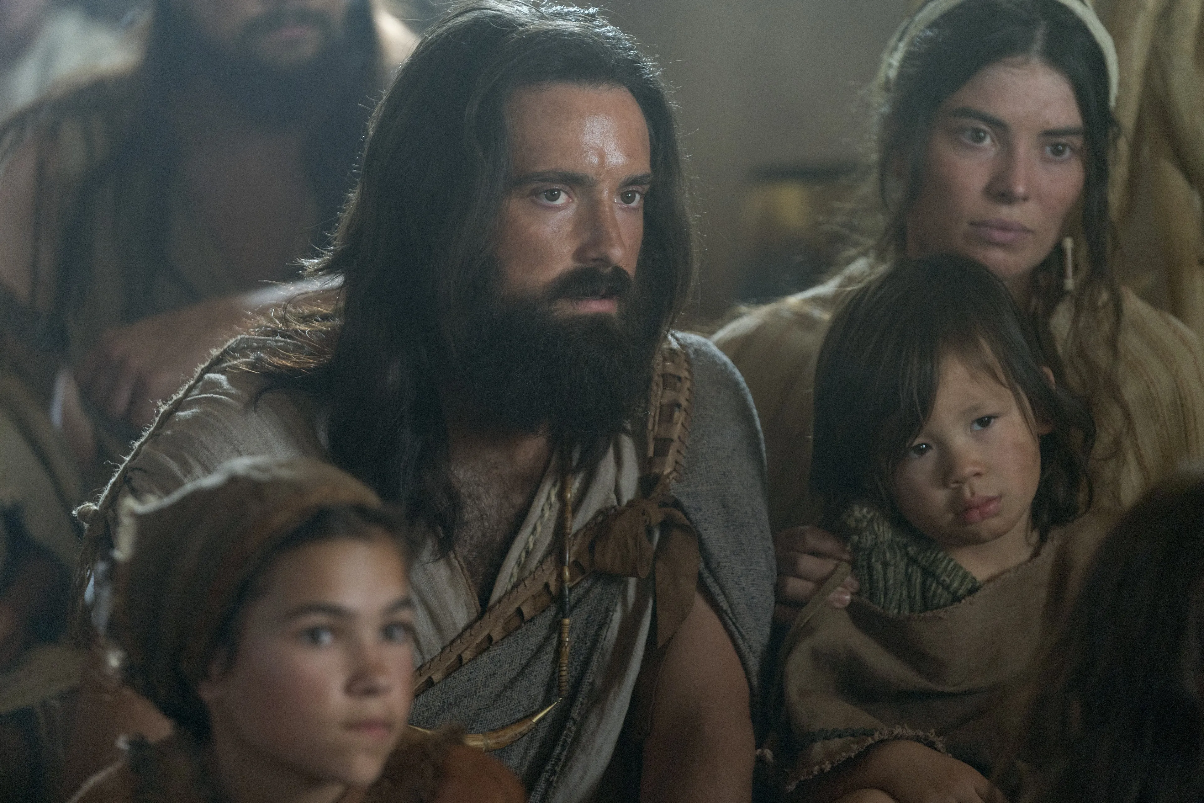 Lamuel and his family listen as Lehi teaches.