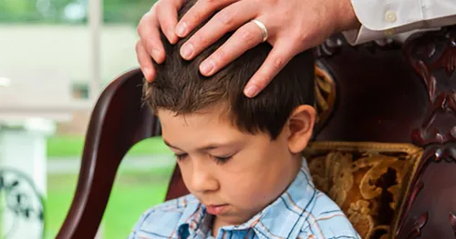 boy receiving blessing