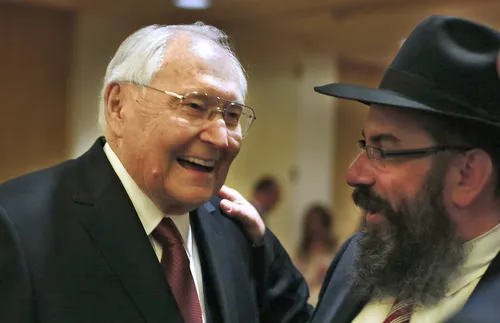 L. Tom Perry and man wearing a hat