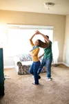 couple dancing in home