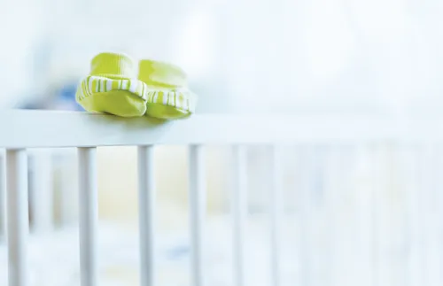 baby shoes on top of a crib