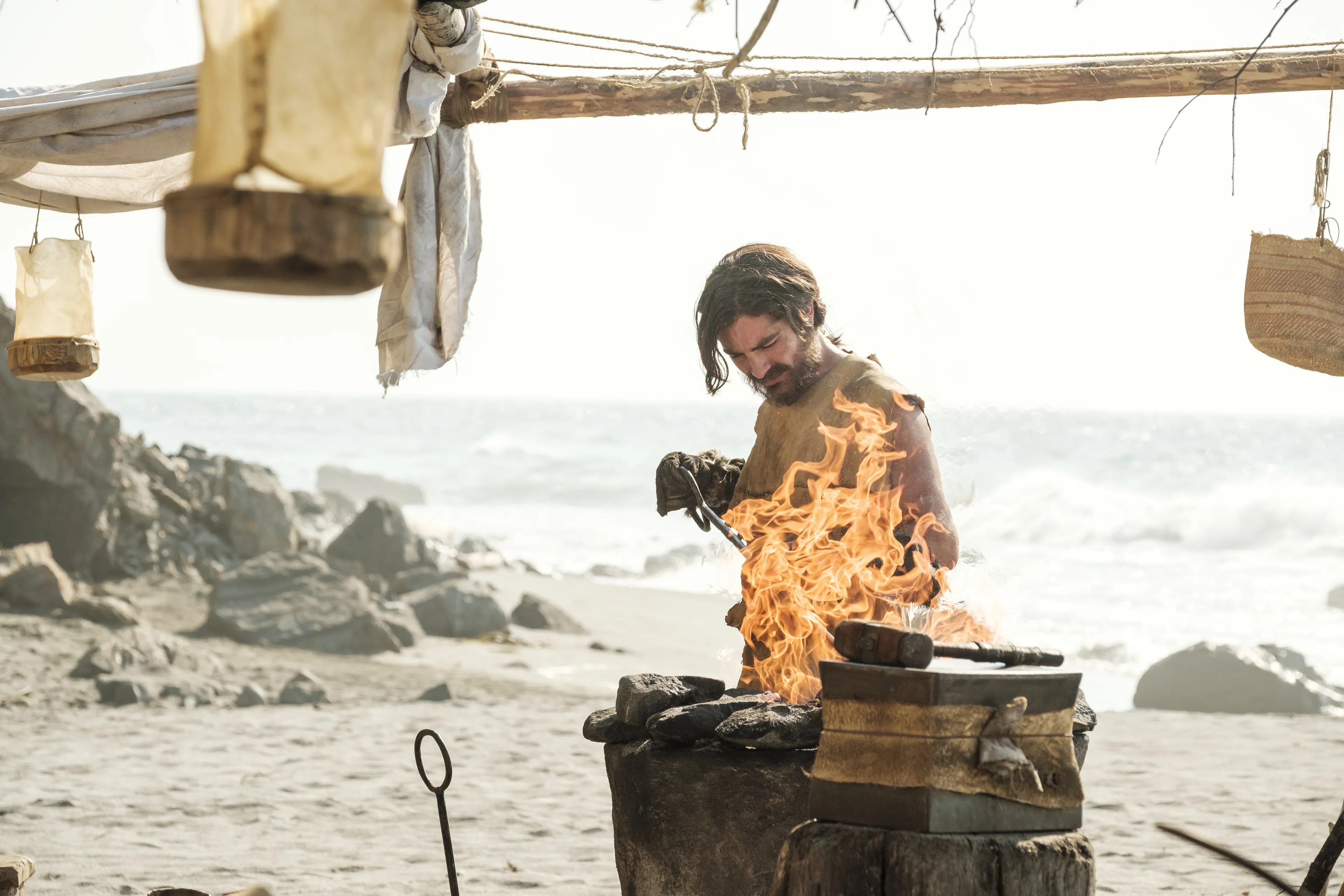 Nephi works the forge on the seashore.