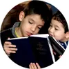 boy reading to his brother