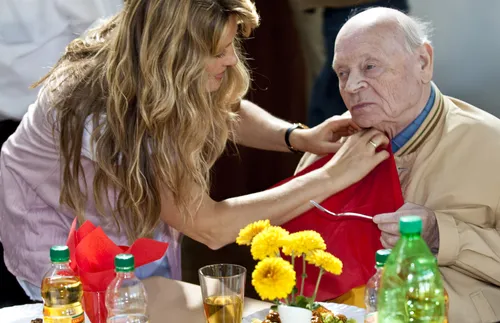 Woman helping older man