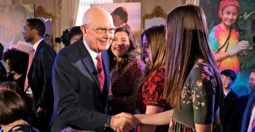 President Oaks shaking young woman’s hand
