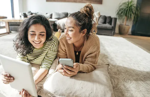 two young women looking at tablet together