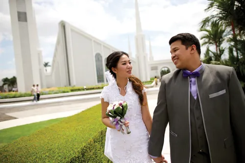 young couple walking in front of temple
