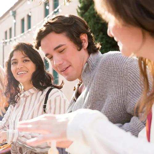 young adults sitting together and smiling