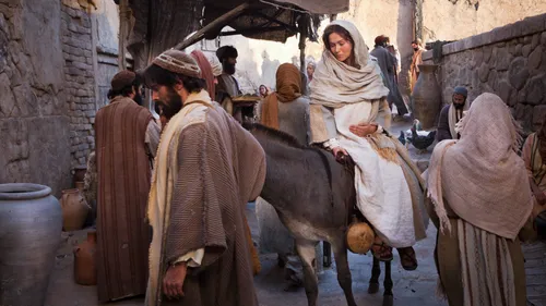 Joseph leading pregnant Mary on a donkey