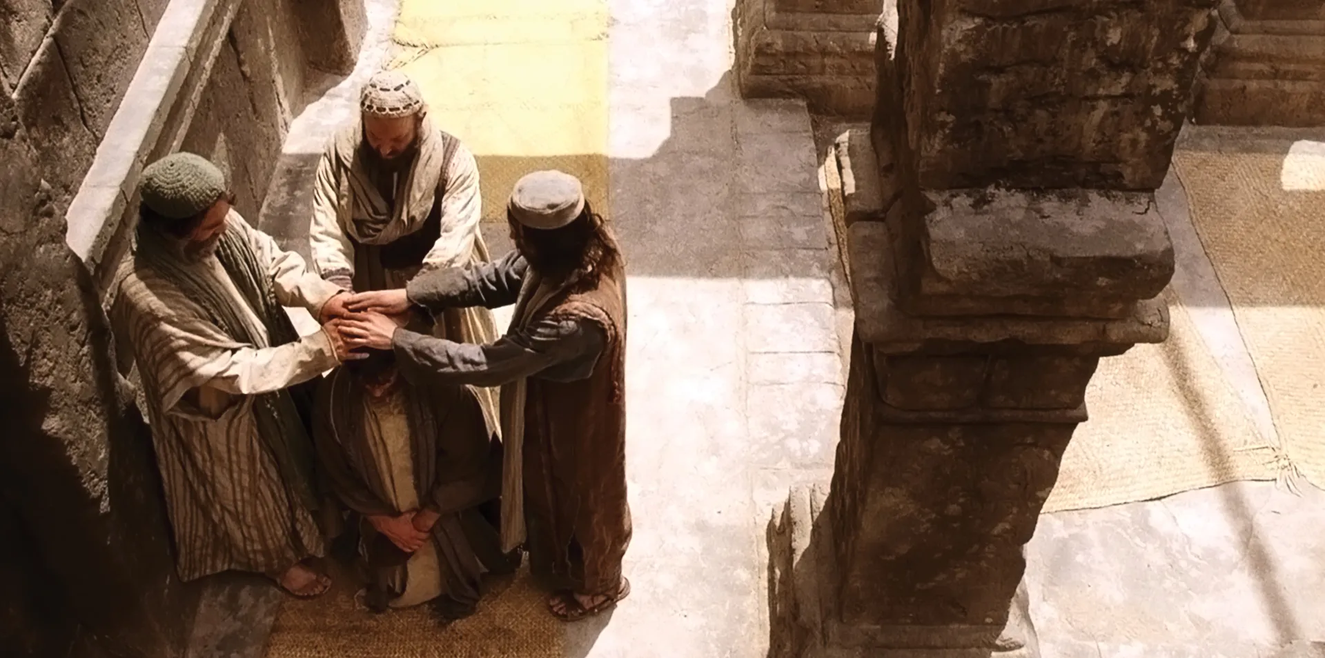 Peter gives Paul the priesthood by the laying on of hands.