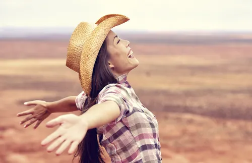 woman rejoicing with open arms