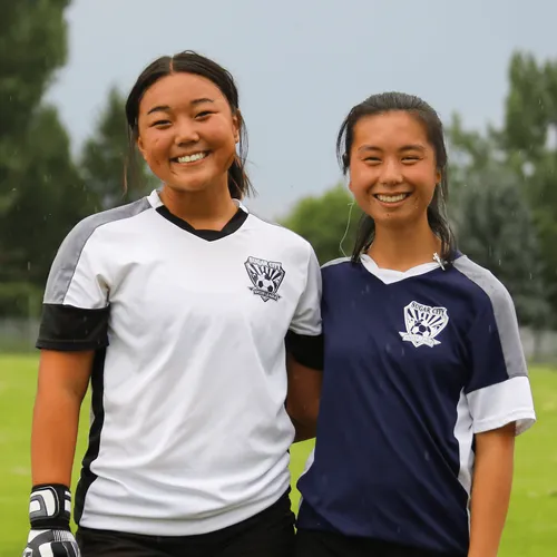 sisters in soccer uniforms