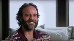 A teary-eyed bearded man