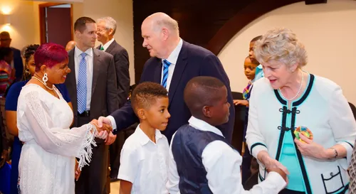 Elder and Sister Renlund shaking hands with members