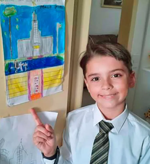 Rafael Derhum Da Fonseca with his artwork on the wall behind him