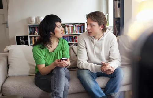 a man and a woman sitting and talking