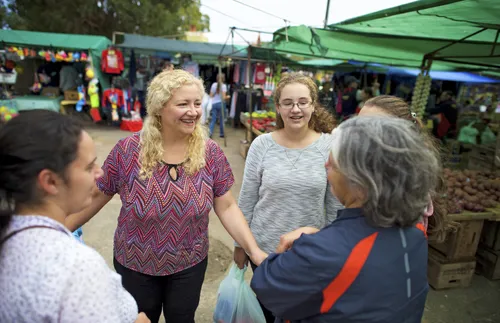 women talking at outdoor market