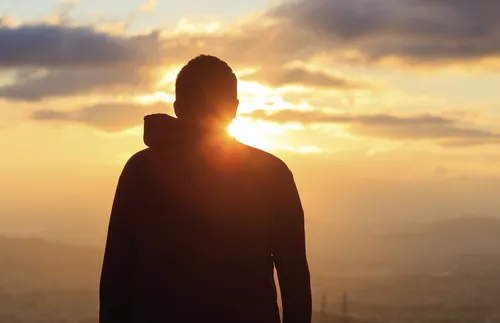 man looking at sunset