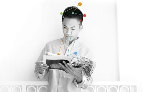 young adult man reading magazine