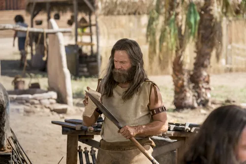 Jacob sharpens a spear.