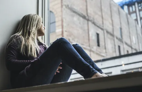 Woman looking out of a window