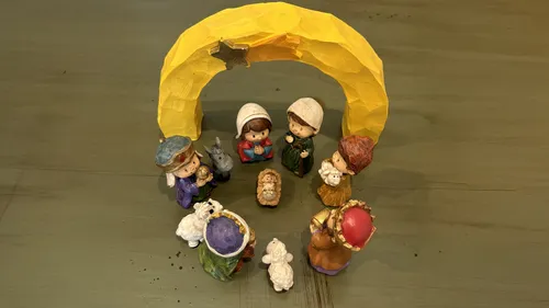 Nativity set with figures all facing Jesus Christ