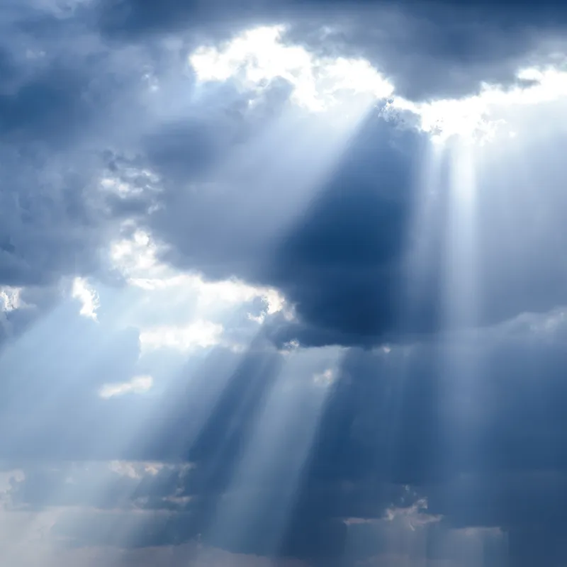 The sun shines through clouds showing God's hand in nature