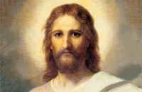 Frontal head and shoulders portrait of Jesus Christ. Christ is depicted wearing a pale red robe with a white and blue shawl over one shoulder. Light emanates from His face.