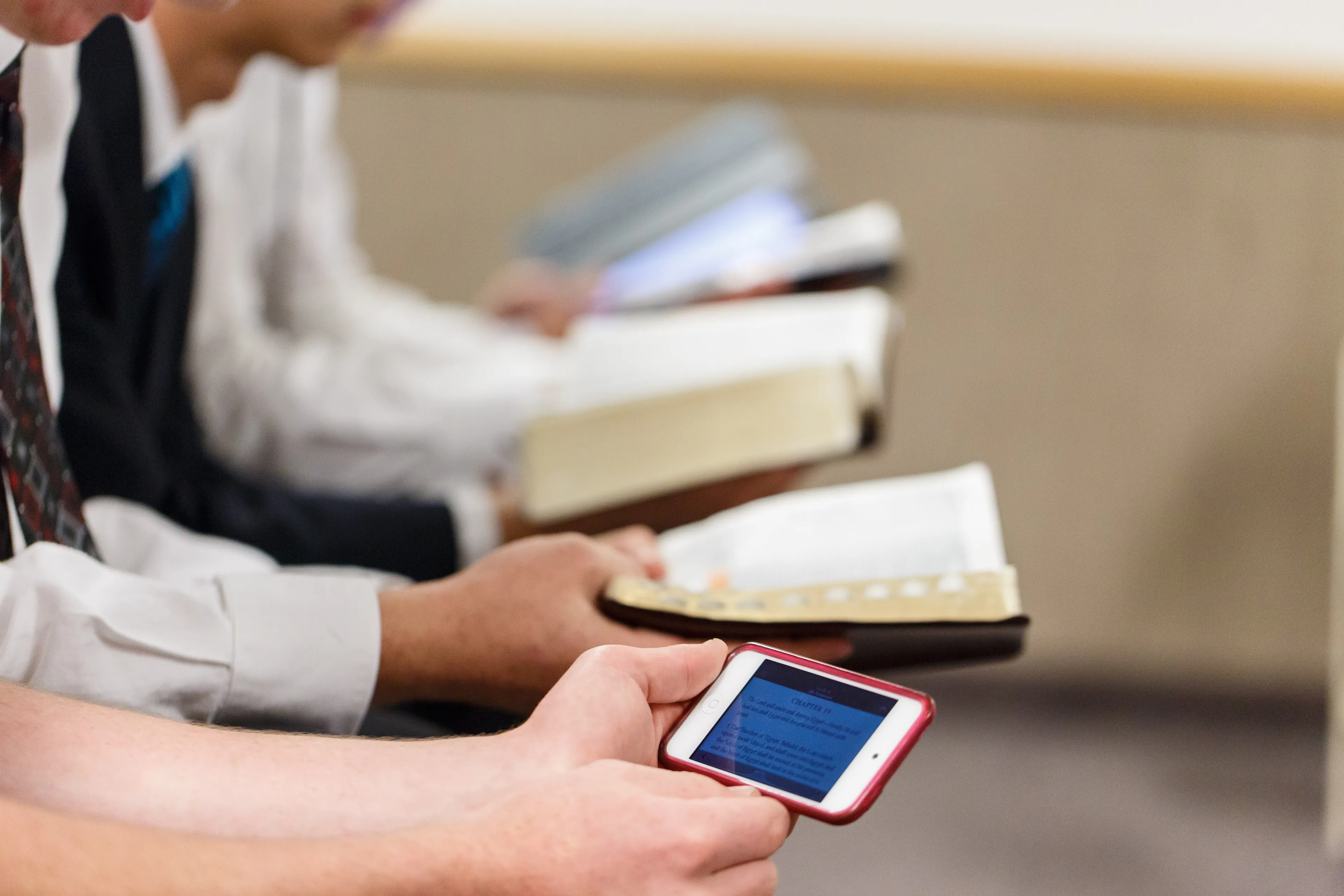 A group of young men reading the scriptures together.