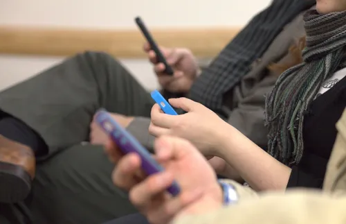 people looking at cell phones