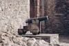cannon outside stone wall