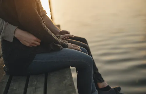 Couple sitting on dock