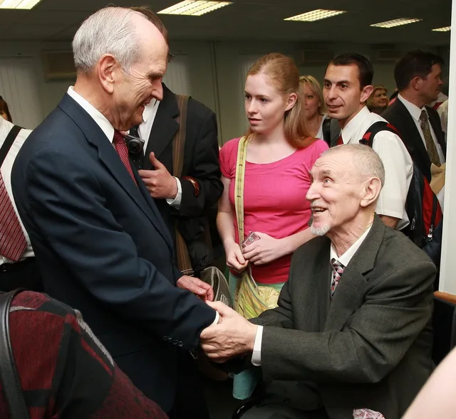 Elder Russell M. Nelson greets Church members in Moscow Russia. 2011.