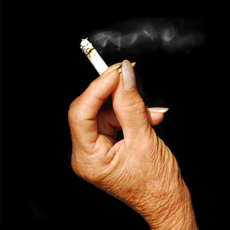 A woman's yellowed hand with a cigarette one of the do not's of the word of wisdom