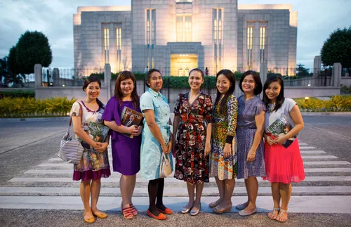 group of young women outside temple