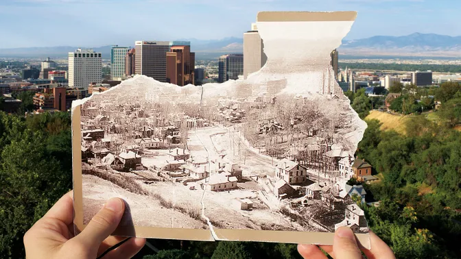 Historical photo held in front of current day landscape.