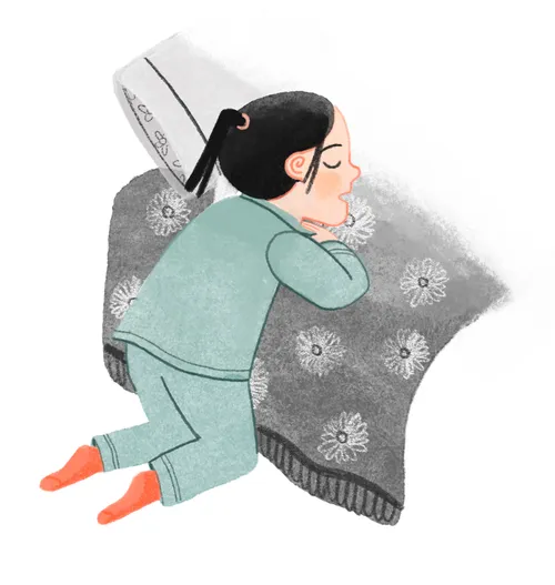 Girl kneeling and praying at her bedside