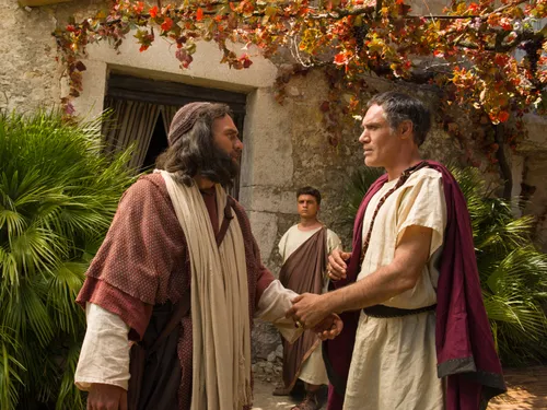 Cornelius greets Peter outside of his home