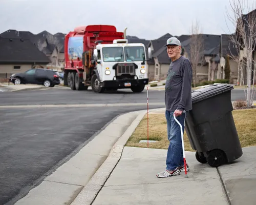 man moving a garbage can