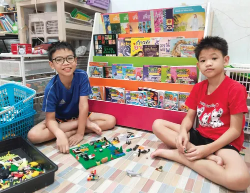 Two boys with toys and books