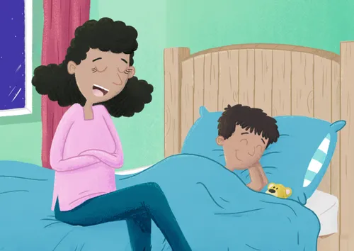 Mom and boy praying on his bed