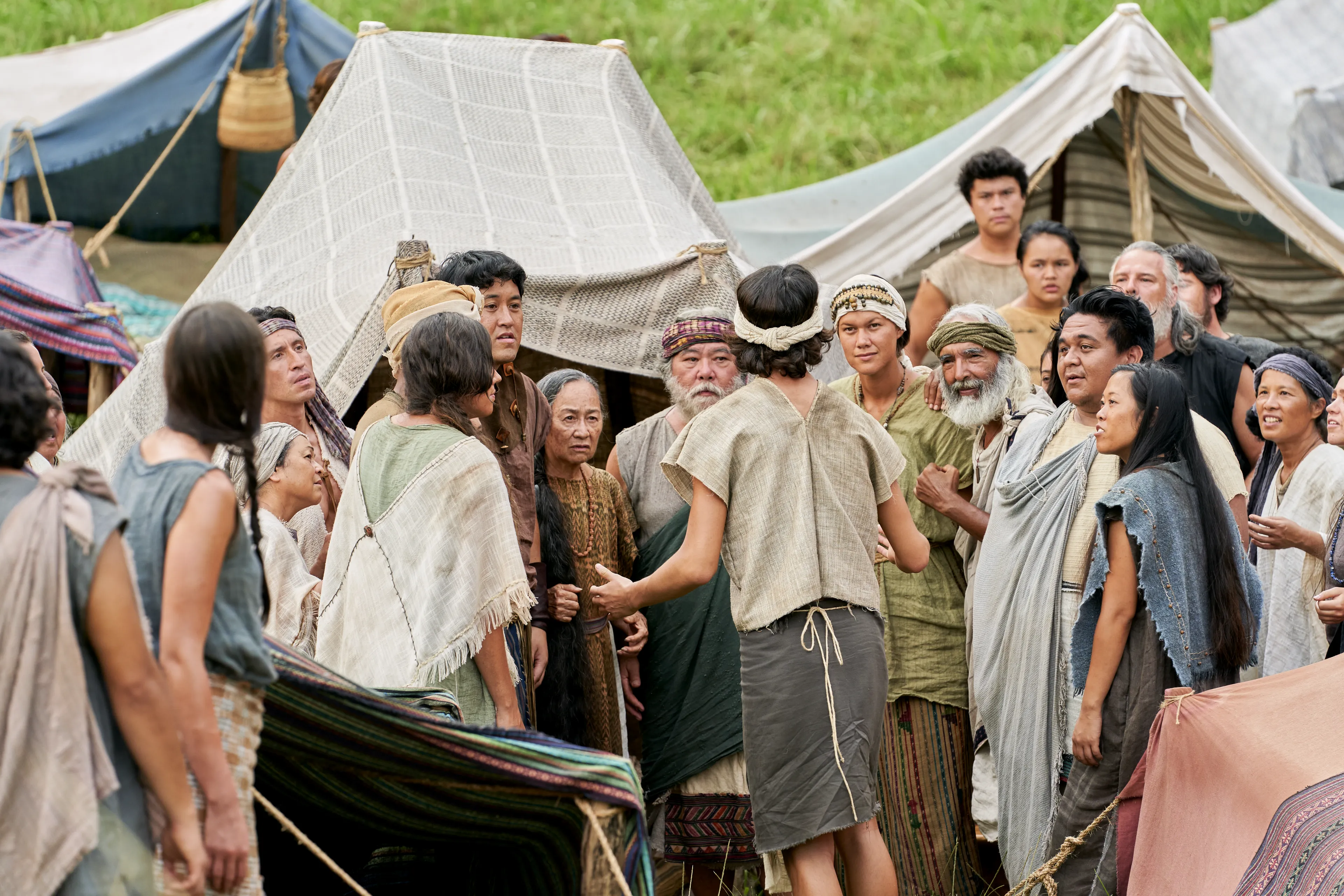 Men and women gather to listen to King Benjamin in the Land of Zarahemla.