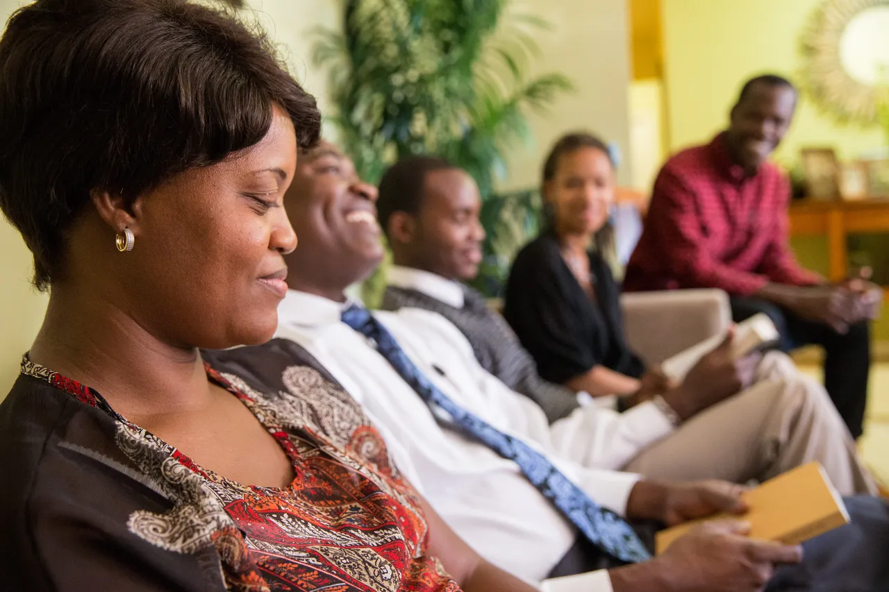 A family sit together learning about the gospel of Jesus Christ