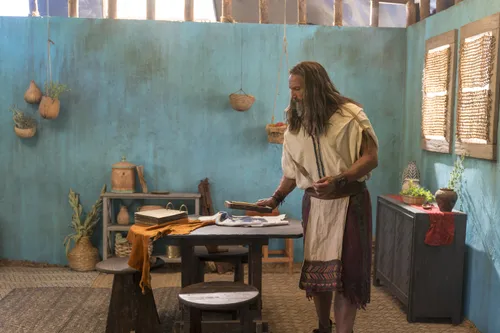 Nephi looks at the metal plates as he prepares to record his testimony.